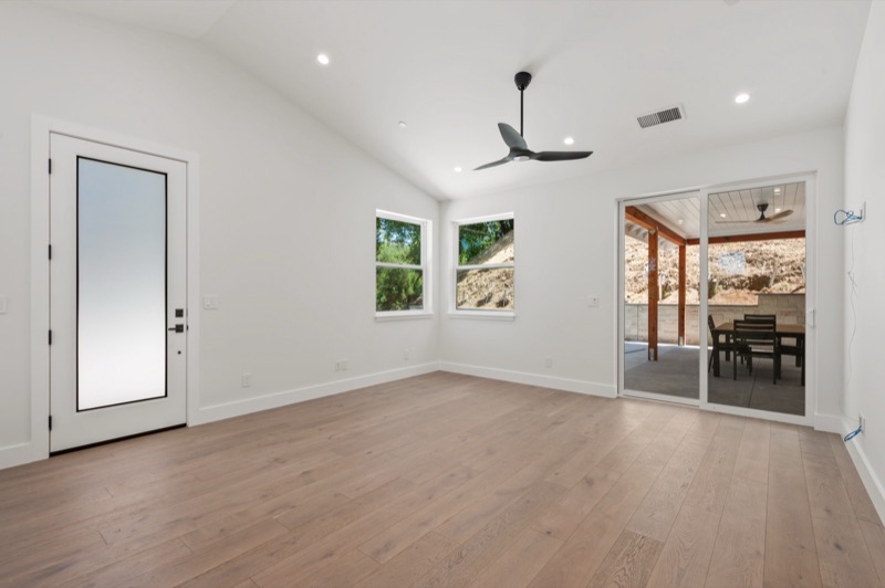 ADU interior with vaulted ceiling and wide-plank oak floors